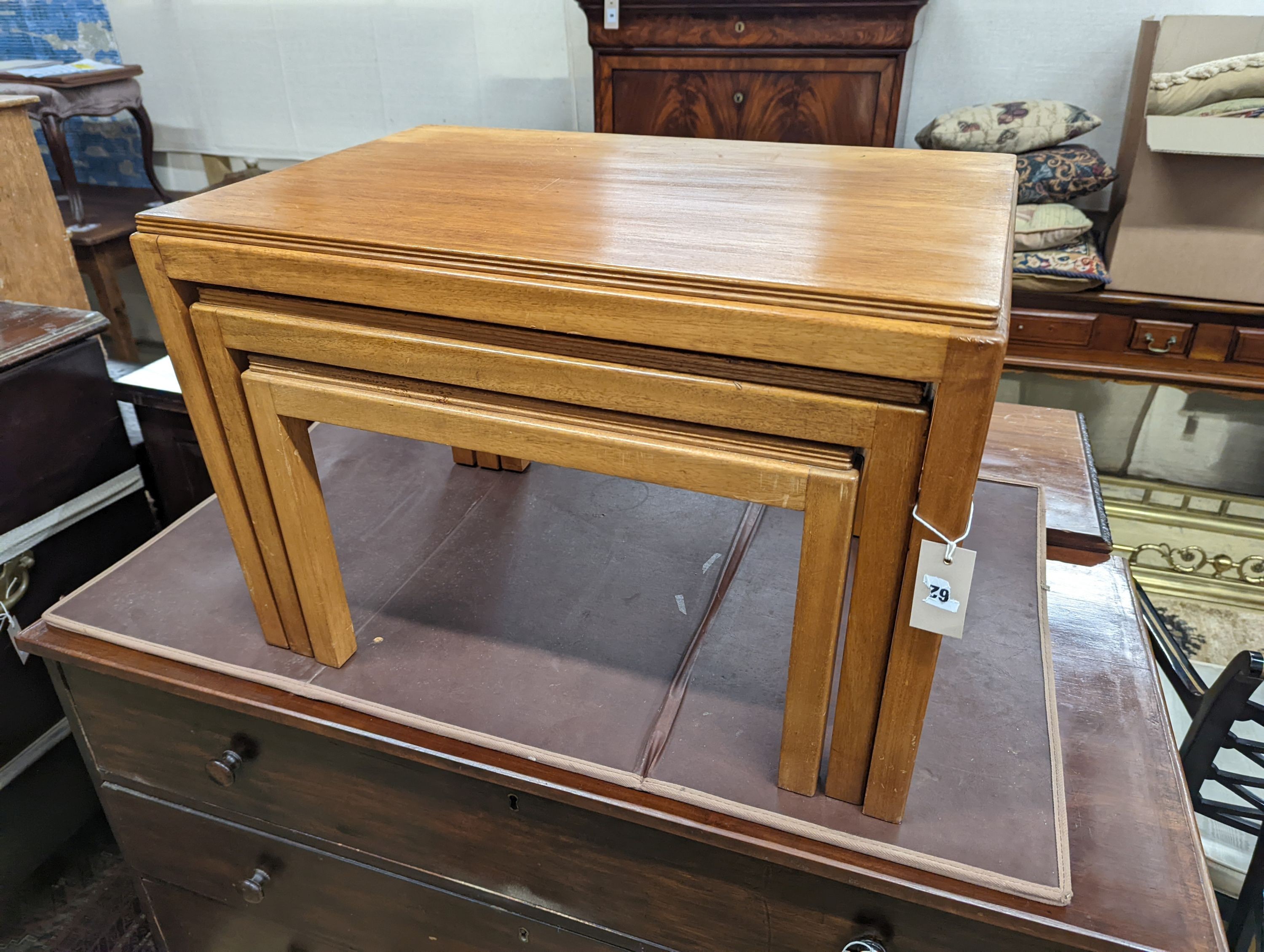 A nest of three Gordon Russell 1960's rectangular teak tea tables, width 68cm, depth 45cm, height 46cm